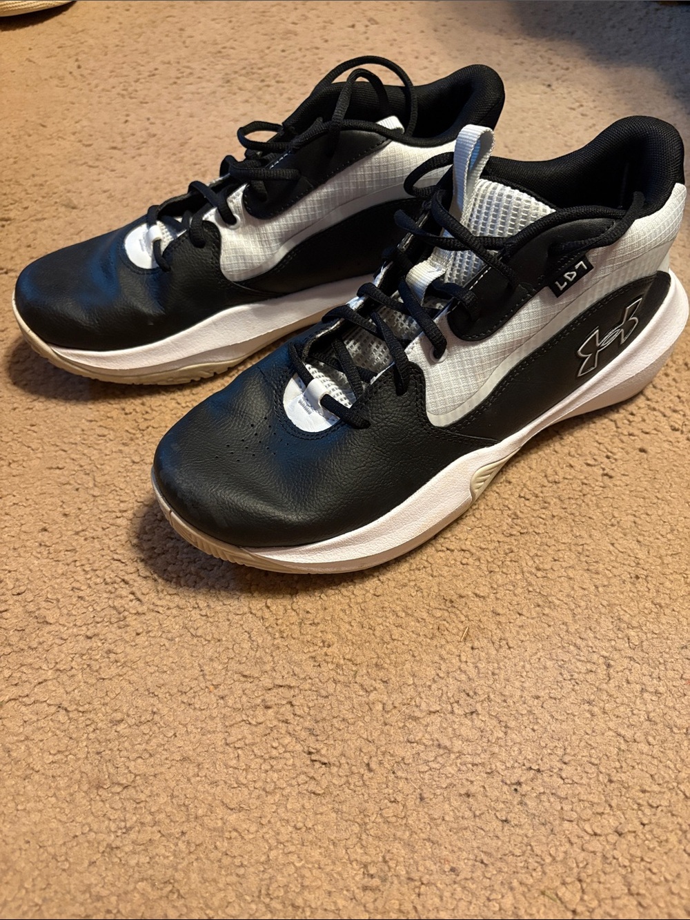 Steph Curry Under Armour Black and White Men's basketball sneakers.